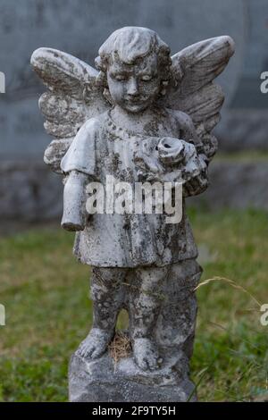 Stone Angel wacht über einen ruhigen Friedhof in Quebec, Kanada. Jahre des Seins in den Elementen sind in der Abnutzung auf der Satzung und die fehlende gezeigt Stockfoto