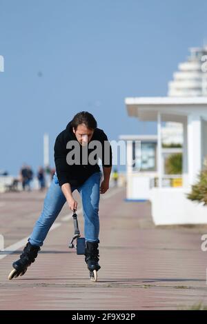 Hastings, East Sussex, Großbritannien. 21 April 2021. UK Wetter: Sonniger Tag heute an der Strandpromenade von Hastings. Ein Mann, der mit einem Selfie-Stick auf der Promenade skaten kann. Foto-Kredit: Paul Lawrenson /Alamy Live Nachrichten Stockfoto