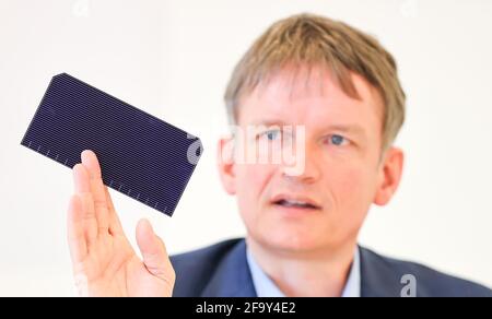 Freiberg, Deutschland. April 2021. Gunter Erfurt, CEO des Solarmodulherstellers Meyer Burger, hält in einer Pressekonferenz ein Solarmodul ab. Die Anlage soll hier ab dem 26. Mai offiziell eröffnet werden. Das sind fast genau zehn Jahre nach der Eröffnung der SolarWorld. Derzeit werden Maschinen installiert und Produktionslinien vorbereitet. Im vergangenen Jahr hatte das Schweizer Unternehmen die Anlage des bankrotten Solarmodulherstellers SolarWorld in Freiberg übernommen. Quelle: Jan Woitas/dpa-Zentralbild/dpa/Alamy Live News Stockfoto