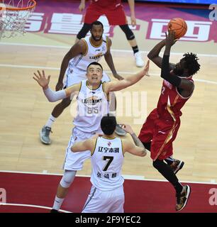 Zhuji, Chinas Provinz Zhejiang. April 2021. Maurice Ndour (R) von Zhejiang Golden Bulls schießt während des Halbfinalmatches zwischen Zhejiang Golden Bulls und Liaoning Flying Leopards in der Saison 2020-2021 der Chinese Basketball Association (CBA) League in Zhuji, Ostchina, Provinz Zhejiang, 21. April 2021. Quelle: Sadat/Xinhua/Alamy Live News Stockfoto