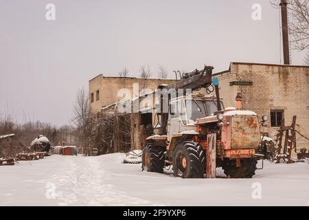 Alte rostige verlassene Traktoren im Winter Stockfoto