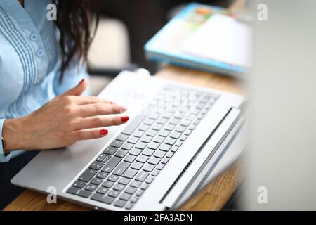 Nahaufnahme eines modernen grauen Laptops, der auf einem Holzdesktop steht Stockfoto
