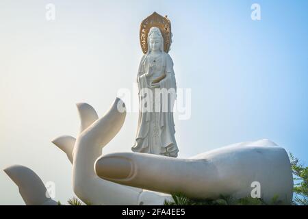 Weiße offene Hand mit Guanyin der Südseestatue Auf der Oberseite davon am Nanshan Buddhismus Kulturparktempel In Sanya auf der Insel Hainan China Stockfoto