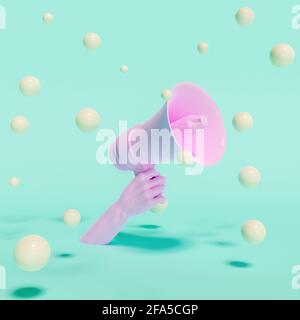 Hand hält ein Megaphon mit schwebenden Kugeln um es herum Stockfoto