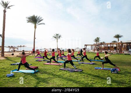 Eine Gruppe von Touristen, die im Hotel Yoga im Freien machen Stockfoto