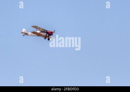 1936 De Havilland DH.87B Hornet Moth Doppeldecker fliegt über die Wash in Norfolk. Stockfoto