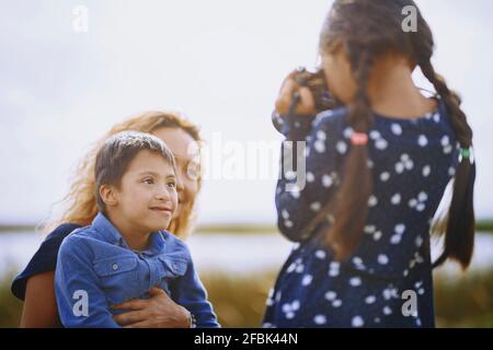 Mädchen fotografieren Mutter und Bruder Stockfoto