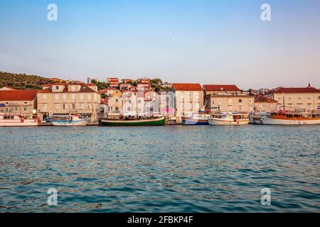 Kroatien, Gespanschaft Split-Dalmatien, Trogir, Boote an der Küste der Insel Ciovo mit Häusern im Hintergrund Stockfoto