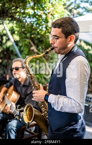 Männlicher Musiker, der Saxophon spielt Stockfoto