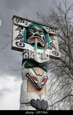 Mond mit menschlichem Geist Gesicht über Bergstock über Bär Königliches Dokument - Carver: Simon Charlie 1957. Cowichan Valley, Vancouver Island, Bridge Stockfoto