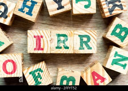 Alphabet letter block in word IRR (Abbreviation of internal rate of return) with another on wood background Stockfoto