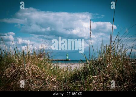 Hinter den Dünen befindet sich der Leuchtturm von Travemünde Stockfoto