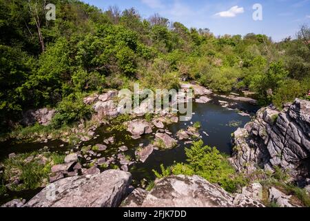 Ruhiger Fluss fließt in Canyon mit überhängenden Klippen an zwei Ufern, Buky Canyon, in der Nähe von Dorf Buki, Tscherkassy Region, Ukraine Stockfoto