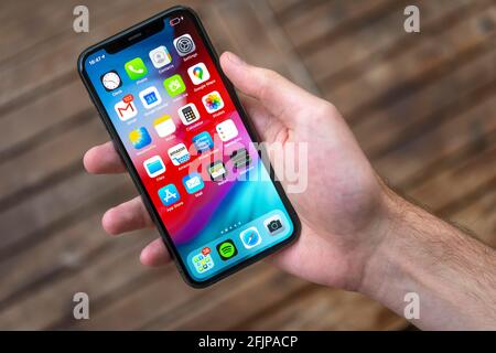 Hand haelt iPhone 11 Pro mit Homescreen, App-Icons, Smartphone Stockfoto