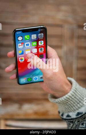 Hand haelt iPhone 11 Pro mit Homescreen, App-Icons, Smartphone Stockfoto