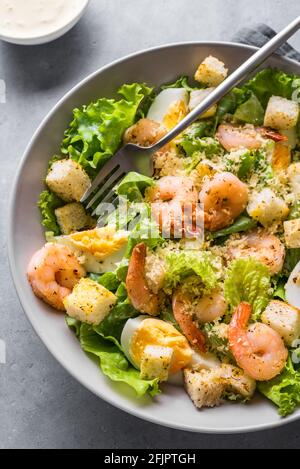 Garnelensalat. Meeresfrüchte Caesar Salat serviert mit Croutons, caesar-Sauce und Parmesan in einer Schüssel aus nächster Nähe. Stockfoto