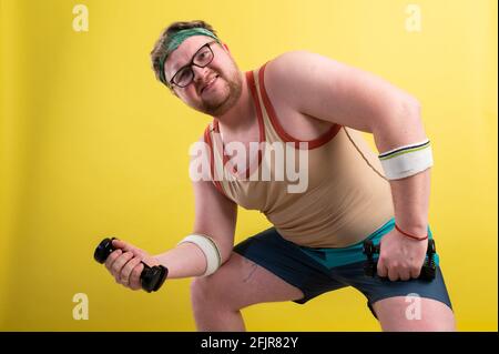 Fetter Mann mit schwarzen Shirt Training mit Hanteln und Kamera Stockfoto