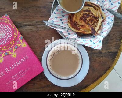 DENPASAR, INDONESIEN - 19. Januar 2021: Roti Canai und teh Tarik mit Hadith Book, Bali, Indonesien, 19. januar 2021 Stockfoto