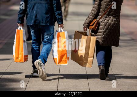 Hannover, Deutschland. April 2021. Passanten gehen mit Papiertüten in den Händen durch das Stadtzentrum. Quelle: Moritz Frankenberg/dpa/Alamy Live News Stockfoto