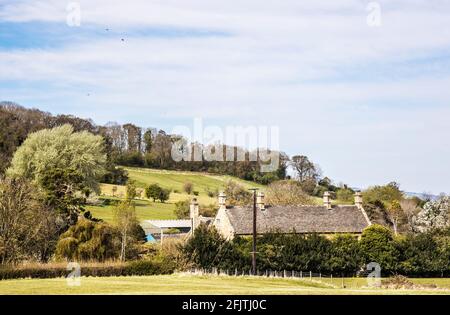 Attraktive Steinhäuser inmitten der hügeligen Landschaft von Cotswold. Stockfoto