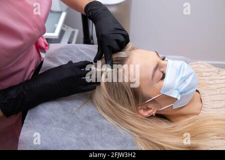 Frau bekommt Injektion in die Haut, Mesotherapie, Haarausfall Therapie. Ärzte tragen Handschuhe im Salon machen medizinische Manipulationen an den Patienten. Nahaufnahme Stockfoto