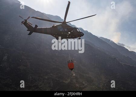 Killarney National Park, Irland - 26. April. 2021: Irish Air Corp Hubschrauber sammeln Wasser, um Feuer im Killarney Nationalpark zu löschen Stockfoto