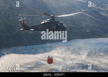 Killarney National Park, Irland - 26. April. 2021: Irish Air Corp Hubschrauber sammeln Wasser, um Feuer im Killarney Nationalpark zu löschen Stockfoto
