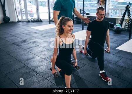 Junge Athleten, die eine Übung mit Handgewichten durchführen Stockfoto