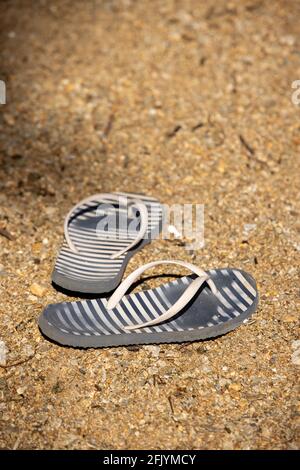 Ein Paar Jandals oder Thongs links am Sandstrand von Lake Hayes, South Island. Neuseeland Stockfoto