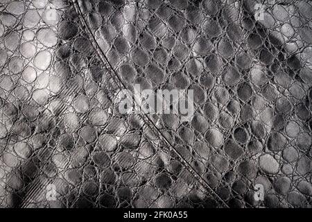 Künstliche schwarze Reptil Leder Textur Hintergrund. Kunstlederstruktur. Stockfoto