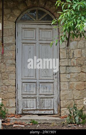 Vertikale Aufnahme einer gewölbten Tür eines Steingebäudes in Rosh Pina, Israel Stockfoto