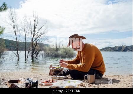 Junger Mann beim Grillen auf dem Feld.Madrid.Spanien Stockfoto