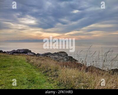 Felsige Küstenlinie des Friday Harbor auf San Juan Island, WA, an einem bewölkten Tag Stockfoto