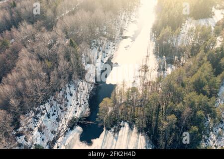 Gefrorener Fluss am sonnigen Frühlingstag, Luftflug auf Drohne über der karelischen Naturlandschaft.