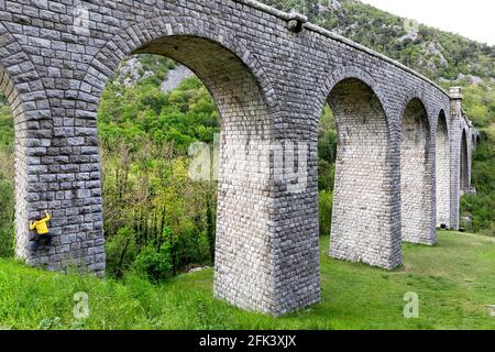 Junge klettert die Solkan-Brücke auf dem Fluss Soca (Isonzo), Slowenien Stockfoto