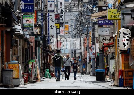 Tokio, Japan. April 2021. Die Menschen gehen entlang der Izakaya Straße in Shimbashi, da alle Tavernen und Fensterläden aufgrund des Ausnahmezustands geschlossen sind. (Foto von James Matumoto/SOPA Images/Sipa USA) Quelle: SIPA USA/Alamy Live News Stockfoto