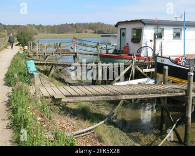 Anlegestellen und Anlegestellen für Hausboote am Ufer des Flusses Deben, während Sie den Fußweg zwischen Melton und Woodbridge entlang gehen. Stockfoto