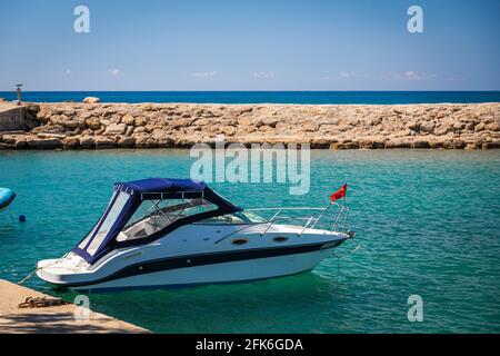 Weißes Segelboot mit türkischer Flagge in der Bucht der antiken Stadt Side, Türkei, verankert, Rückansicht Stockfoto