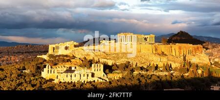 Panorama von Athen mit Akropolis Hügel bei dramatischem Sonnenuntergang, Griechenland. Die Akropolis von Athen auf einem felsigen Ausbiss über der Stadt Athen und con Stockfoto