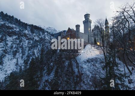 Schwangau, Deutschland - 27. Dezember 2014: Schloss Neuschwanstein in der Dämmerung in Schwangau im Landkreis Ostallgäu in Bayern, Deutschland. Stockfoto