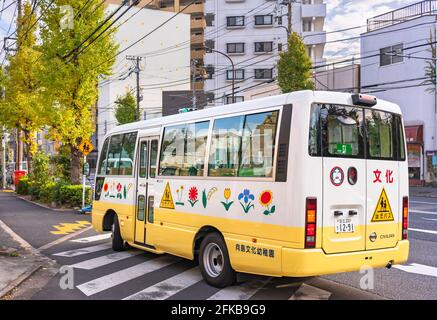 tokio, japan - märz 30 2021: Japanischer Kindergarten Schulbus mit Aufklebern von Blumenbildern und Schulwarnschild auf einem Pedal geschmückt Stockfoto