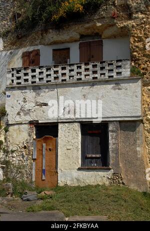 Reif für die Renovierung und viele TLC … Verwittertes und vertauftes, in Kalksteinfelsen geschnittenes troglodytes Wohnhaus in der Rue Victor Hugo in Amboise, Loire-Tal, Centre-Val de Loire, Frankreich, bietet eine alternative unterirdische Lebensweise oder eine Investitionsmöglichkeit als erstes oder zweites Haus oder Ferienhaus. Obwohl einige der Tausenden Höhlen entlang der Loire inzwischen stillstehen und verfallen sind, hat das neue Interesse am Leben in der Tropodyte die Umwandlung anderer in Sommerhäuser, Ferienunterkünfte, Weinkeller, Pilzfarmen, Museen und Restaurants veranlasst. Stockfoto