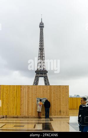 Menschen, die die Baustelle betrachten und umhergehen, sichern sich mit dem Eiffelturm im Hintergrund ein Fechten, Paris, 2014. Stockfoto