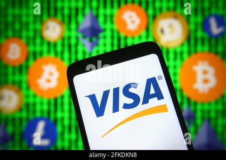 Ukraine. April 2021. In dieser Abbildung ist das Visa-Logo auf einem Smartphone-Bildschirm vor Kryptowährungsschildern zu sehen. (Foto von Pavlo Gonchar/SOPA Images/Sipa USA) Quelle: SIPA USA/Alamy Live News Stockfoto