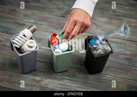 Ökologie Konzept, eine Menge verwertbare Objekte im Container auf dem Holz- Hintergrund. Stockfoto