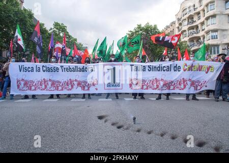 Barcelona, Spanien. Mai 2021. Die Demonstranten wurden mit Fahnen der Gewerkschaften gesehen, die ein Banner trugen, auf dem stand, dass es während der Demonstration lang lebe die Arbeiterklasse, der Gewerkschaftsbund Kataloniens, mit dem Slogan "das Land ist der Arbeiterklasse gegenüber verschuldet", Die Arbeiterkommissionen (CC.OO) und die Allgemeine Gewerkschaft der Arbeitnehmer (UGT) forderten am 1. Mai eine Demonstration zum Internationalen Tag der Arbeiter. (Foto von Thiago Prudencio/SOPA Images/Sipa USA) Quelle: SIPA USA/Alamy Live News Stockfoto