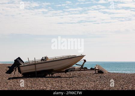 Schnellboot auf einem Kiesstrand in West Sussex, Großbritannien Stockfoto