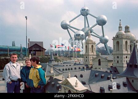 Drei junge Jungen posieren einige Monate nach der Einweihung des Mini-Europe am 1990. April im Hintergrund das Atomium, Brüssel, Belgien Stockfoto