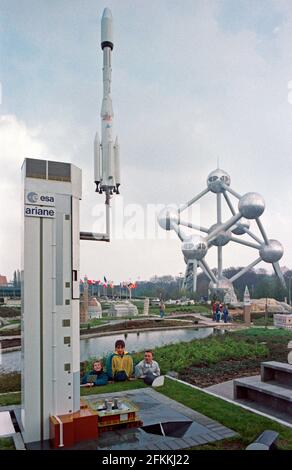 Drei junge Jungs posieren bei Mini-Europe, ESA Ariane Rocket, wenige Monate nach seiner Einweihung, am 1990. April, im Hintergrund das Atomium, Brüssel, Belgien Stockfoto