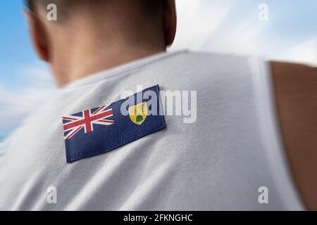 Die Nationalflagge der Turks- und Caicosinseln auf der Der Rücken des Athleten Stockfoto